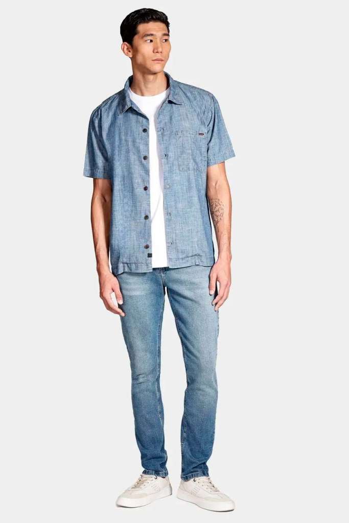 Homem vestido com camisa jeans e calça azul