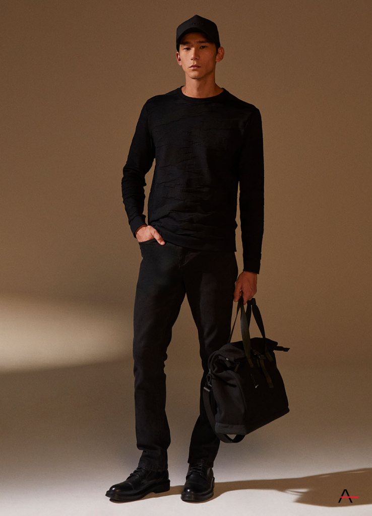 Modelo masculino em look total black com bolsa