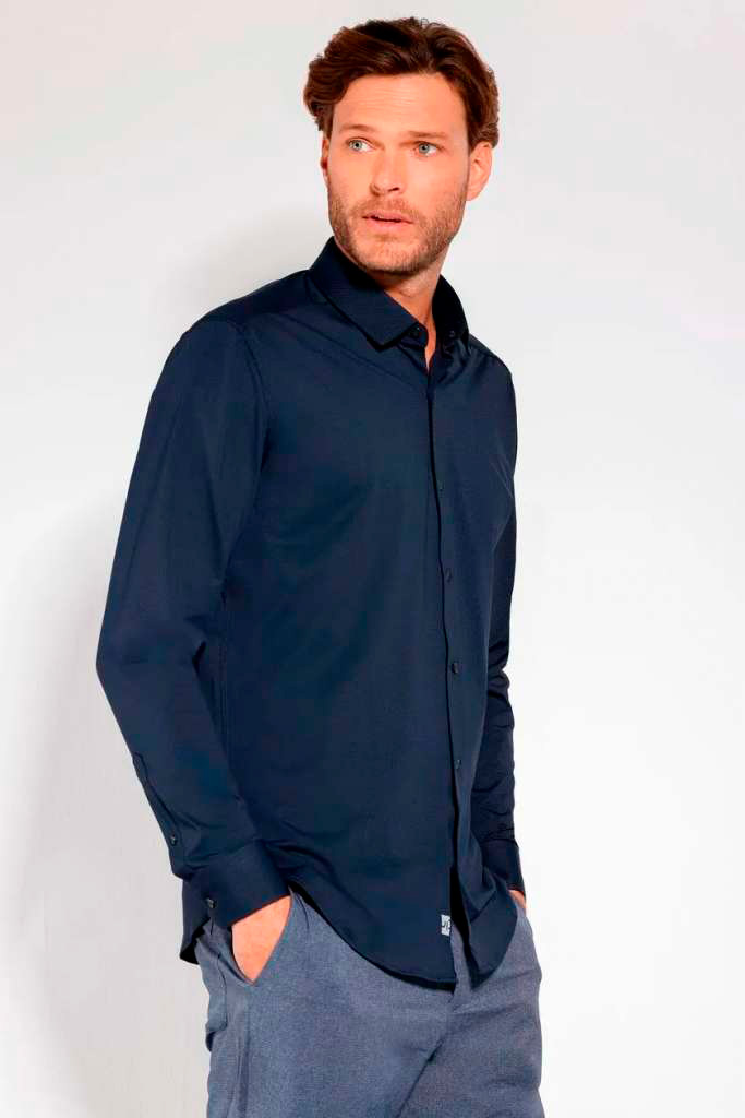Homem usando camisa social azul escuro.