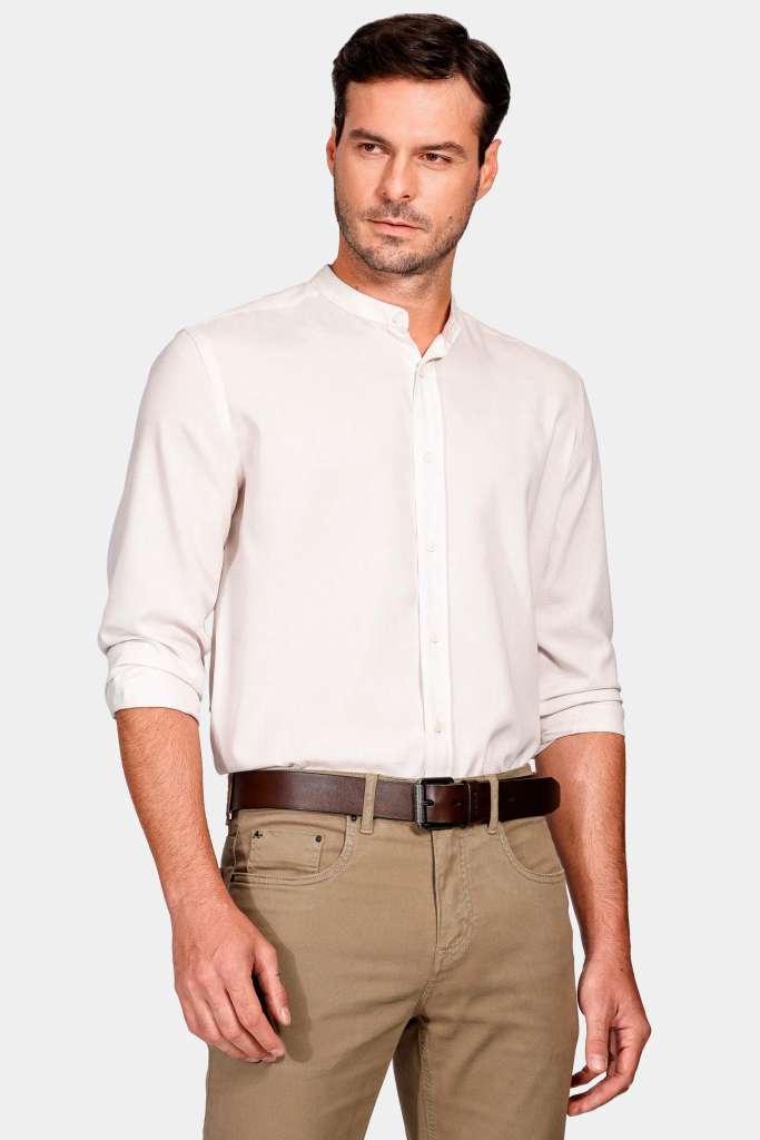modelo masculino usando uma camisa branca e uma calça marrom com um cinto preto em um fundo branco 